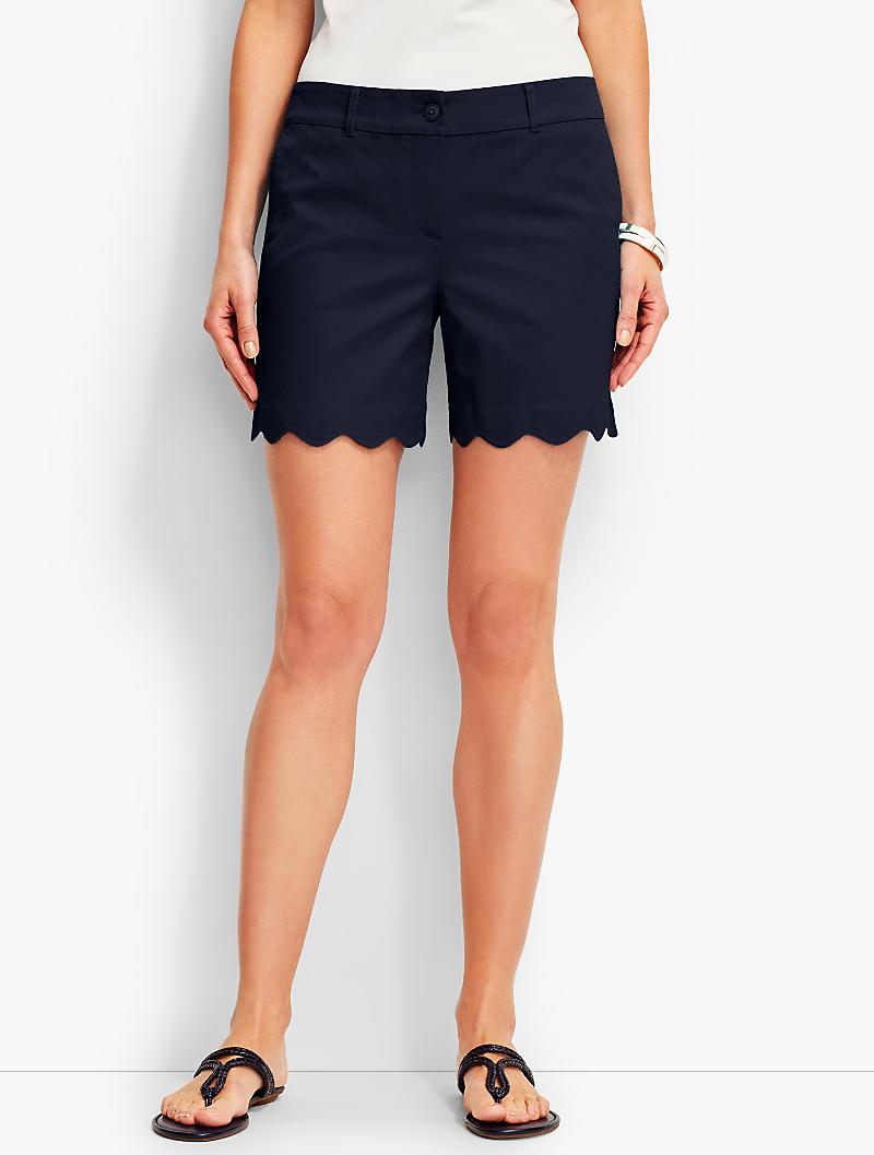 Scalloped Shorts This solid rashguard with delicate scallop and laser cut design is a staple for any sun protective wardrobe. Match this up with any of our beach pants, bikini bottoms, or swim skirts for a fashionable beach to street look.